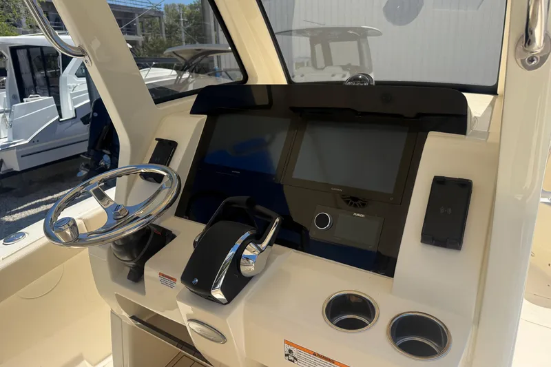 Slide: The Image of Helm of 2026 Scout 260 LXF boat with steering wheel and navigation controls. - 9
