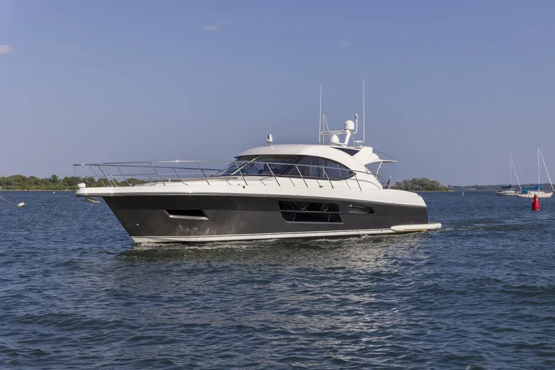 The Image of 2016 Riviera 5000 Sport Yacht cruising on a sunny day. - 0