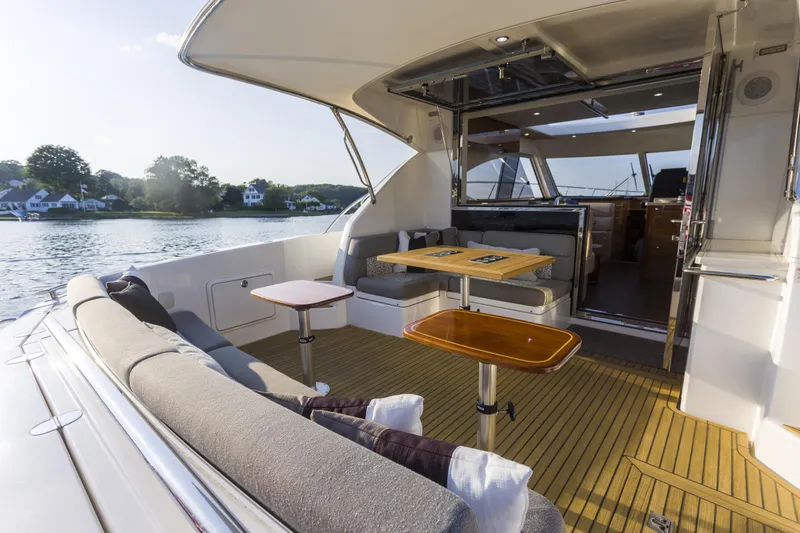 Slide: The Image of Luxurious 2016 Riviera 5000 Sport Yacht with spacious outdoor seating and scenic water view. - 14