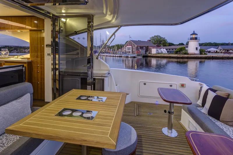 Slide: The Image of Luxurious 2016 Riviera 5000 Sport Yacht interior with waterfront view and lighthouse in background. - 15