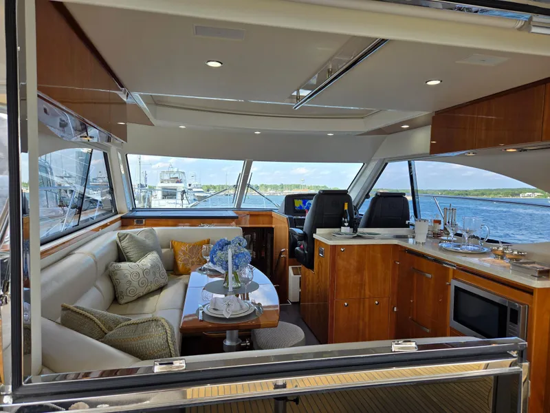Slide: The Image of Luxurious interior of 2016 Riviera 5000 Sport Yacht with elegant seating and dining area. - 17