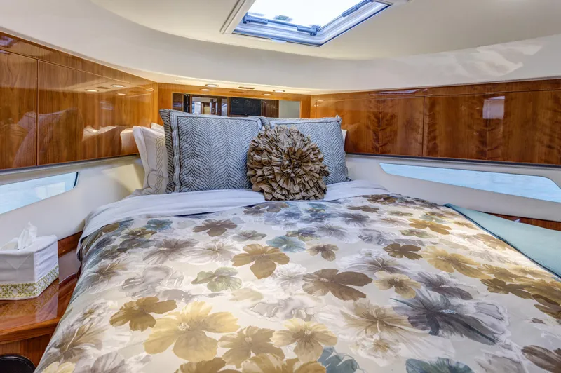 Slide: The Image of Luxurious bedroom interior of 2016 Riviera 5000 Sport Yacht with floral bedding. - 26