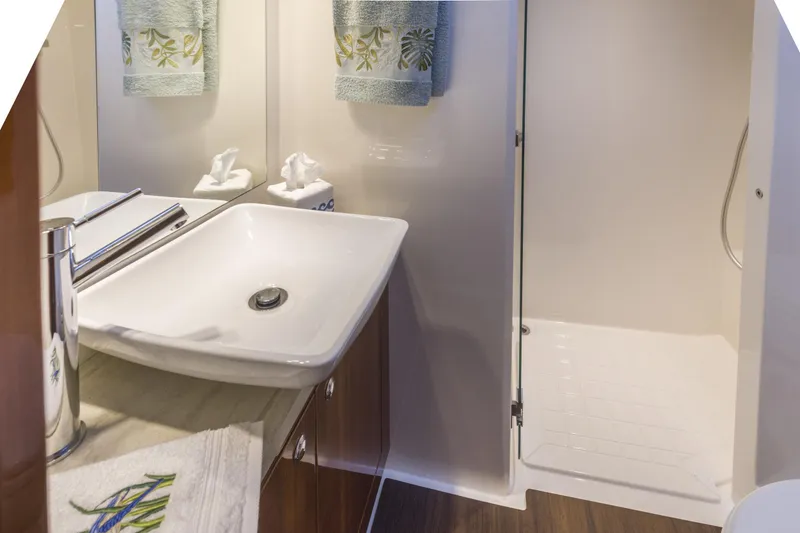 Slide: The Image of Luxurious bathroom in 2016 Riviera 5000 Sport Yacht with modern sink and shower. - 27