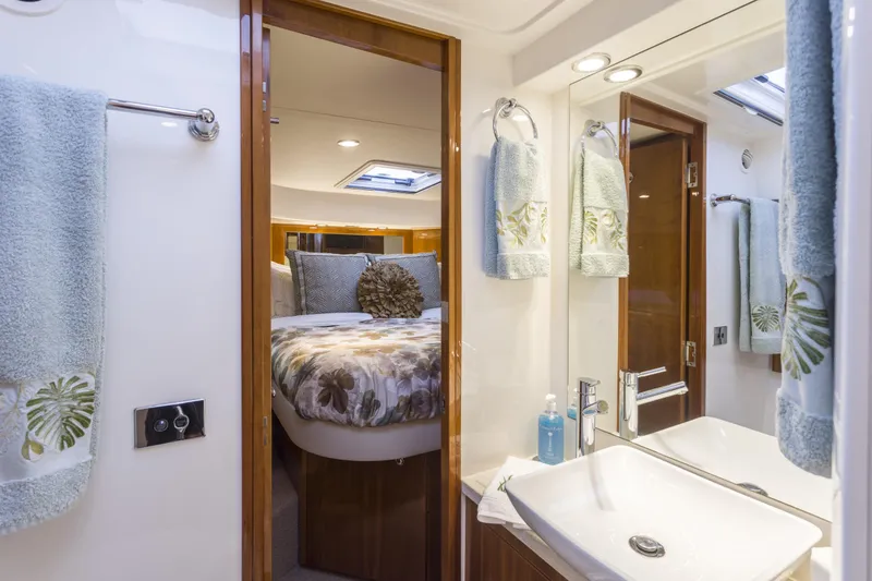 Slide: The Image of Luxurious 2016 Riviera 5000 Sport Yacht interior with elegant bedroom and bathroom. - 28