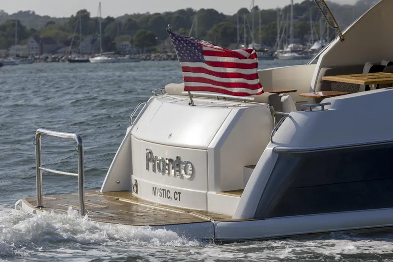 Slide: The Image of 2016 Riviera 5000 Sport Yacht with American flag, cruising near Mystic, CT. - 3