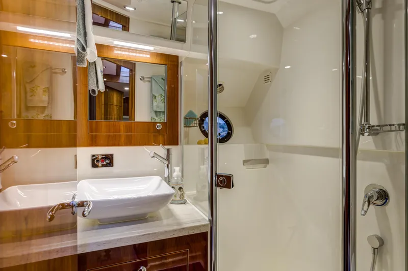 Slide: The Image of Luxurious bathroom in 2016 Riviera 5000 Sport Yacht with modern fixtures and elegant design. - 30