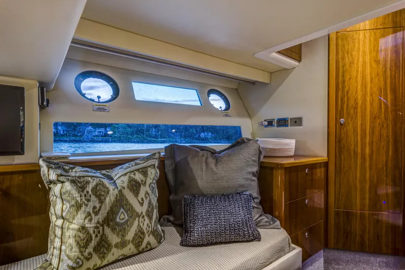 Slide: The Image of Luxurious interior of 2016 Riviera 5000 Sport Yacht with plush cushions and wooden cabinetry. - 33
