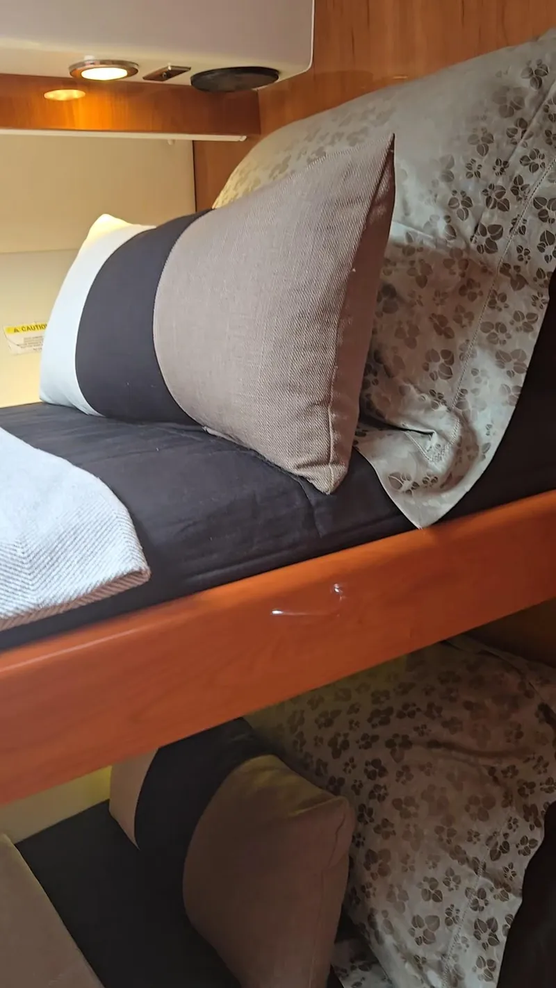 Slide: The Image of Interior of 2016 Riviera 5000 Sport Yacht with cozy bedding and pillows. - 34