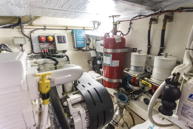 Slide: The Image of Engine room of 2016 Riviera 5000 Sport Yacht with fire extinguisher and machinery. - 40