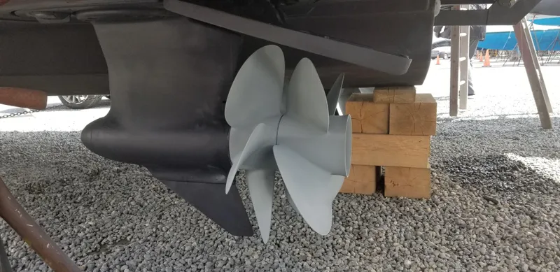 Slide: The Image of Propeller of 2016 Riviera 5000 Sport Yacht on gravel with wooden support blocks. - 42