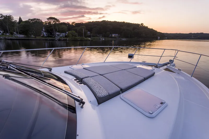 Slide: The Image of 2016 Riviera 5000 Sport Yacht at sunset on tranquil water. - 6