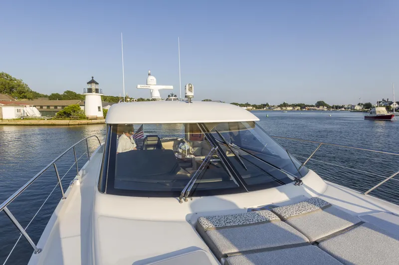 Slide: The Image of 2016 Riviera 5000 Sport Yacht cruising near a lighthouse on a sunny day. - 9