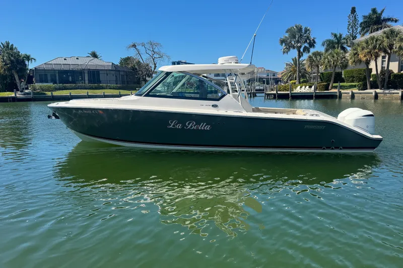 The Image of 2016 Pursuit DC 325 Dual Console boat named "La Bella" on calm water. - 0