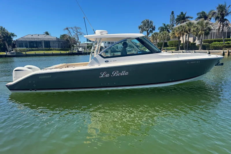 Slide: The Image of 2016 Pursuit DC 325 Dual Console boat named "La Bella" on calm water. - 10