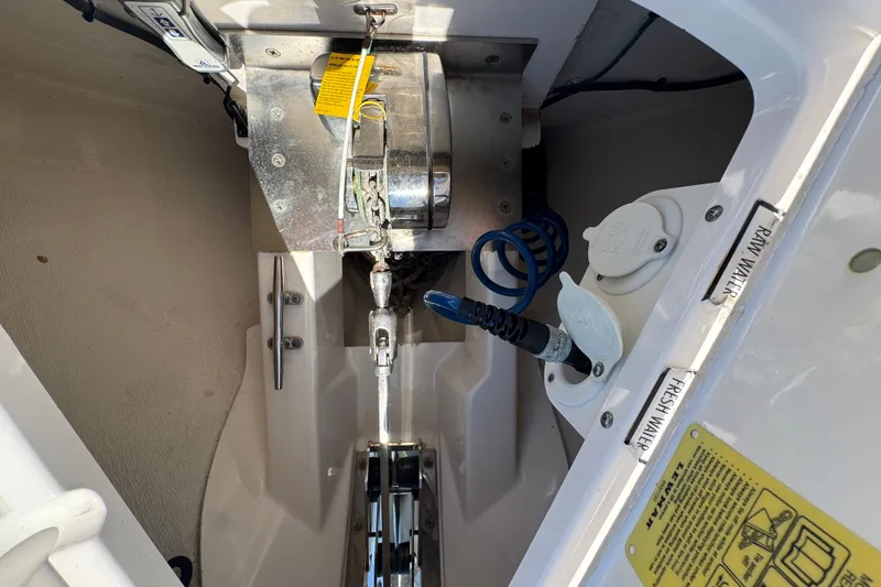 Slide: The Image of Anchor compartment of 2016 Pursuit DC 325 Dual Console boat with winch and water connections. - 32