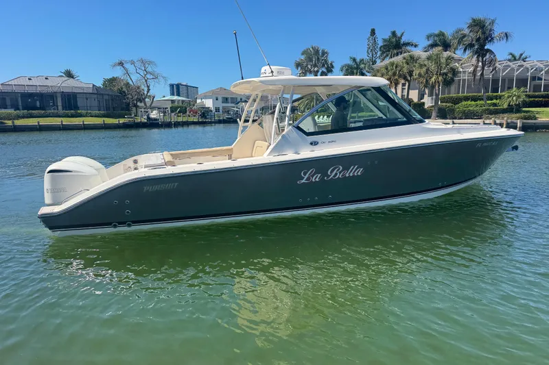 Slide: The Image of 2016 Pursuit DC 325 Dual Console boat named "La Bella" on calm water. - 37