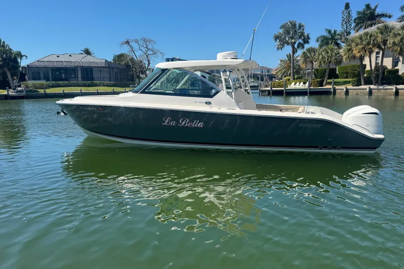 Slide: The Image of 2016 Pursuit DC 325 Dual Console boat named "La Bella" on calm water. - 41