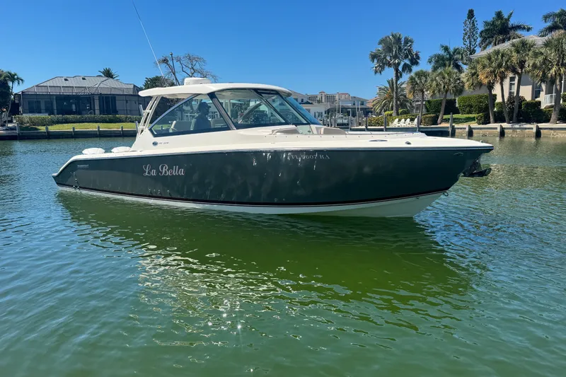 Slide: The Image of 2016 Pursuit DC 325 Dual Console boat named "La Bella" on calm water. - 9