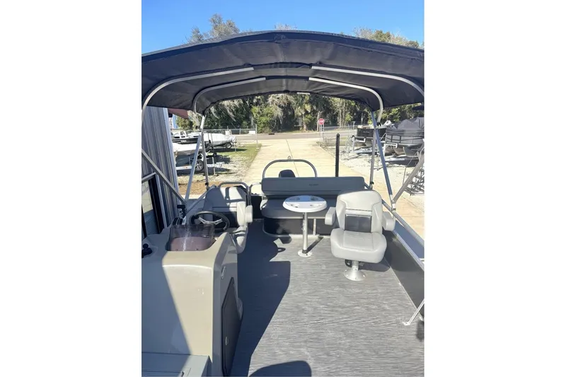 Slide: The Image of 2022 Lowe Ultra 182 Fish & Cruise pontoon boat interior with seating and canopy. - 6