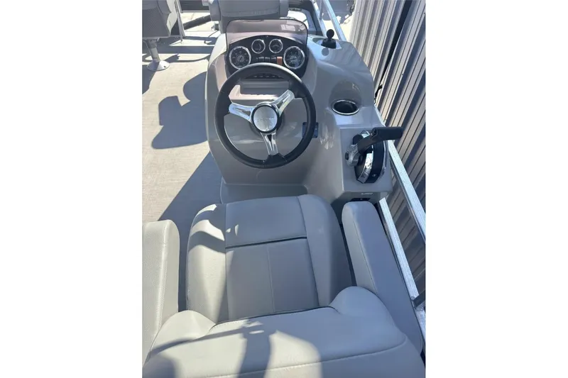 Slide: The Image of 2022 Lowe Ultra 182 Fish & Cruise boat helm with steering wheel and controls. - 7