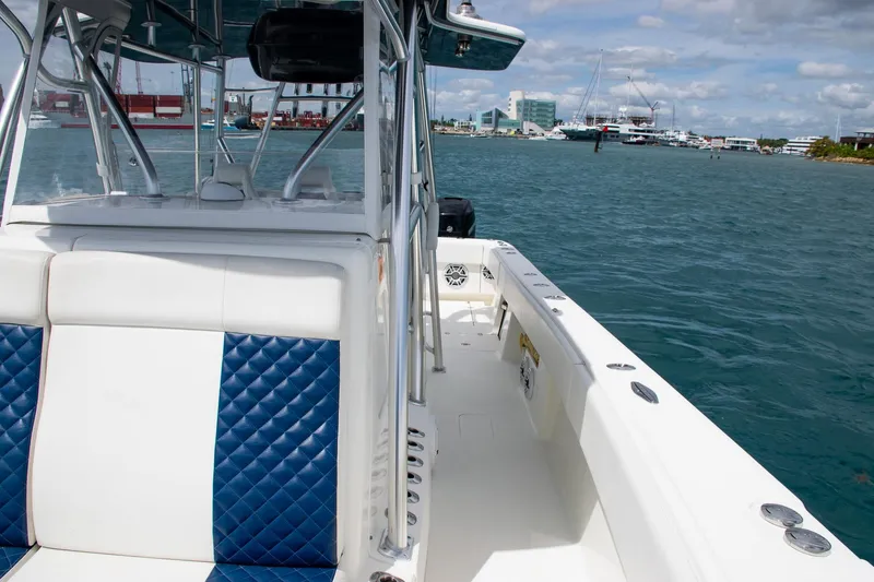 Slide: The Image of 2022 SeaVee 390Z boat with blue and white seating on open water. - 18