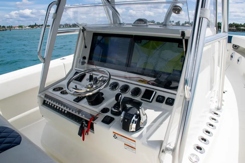 Slide: The Image of 2022 SeaVee 390Z boat console with steering wheel and navigation screens. - 21