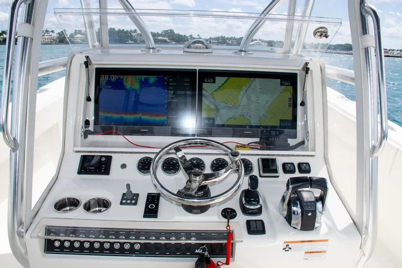 Slide: The Image of 2022 SeaVee 390Z boat dashboard with navigation screens and controls. - 22