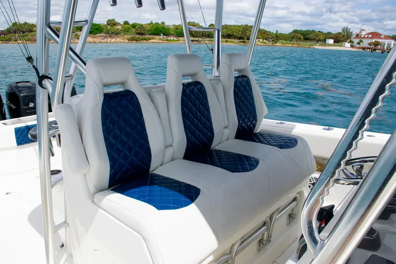 Slide: The Image of 2022 SeaVee 390Z boat with luxurious blue and white seating on a sunny day. - 25