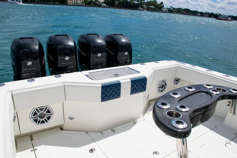 Slide: The Image of 2022 SeaVee 390Z boat with four powerful outboard engines on a sunny day. - 32