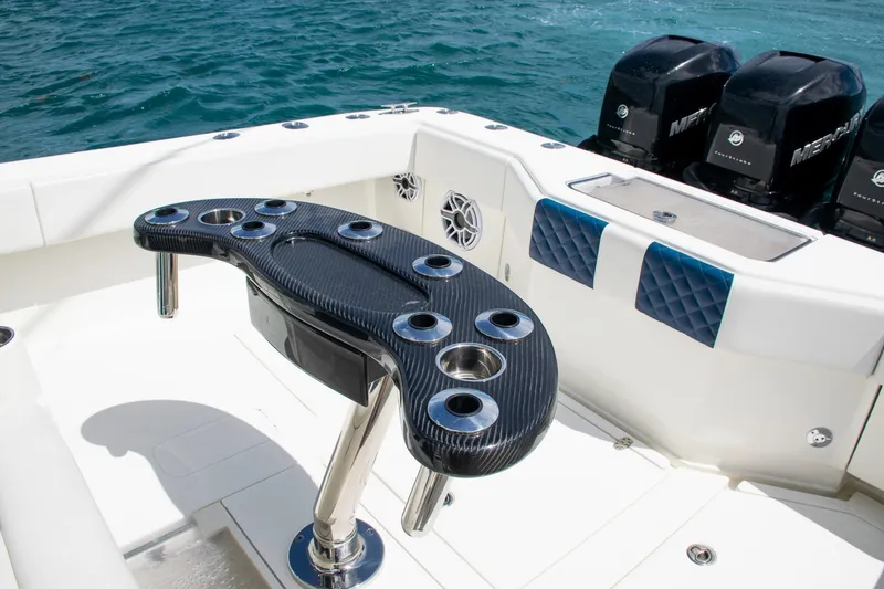 Slide: The Image of 2022 SeaVee 390Z boat deck with rod holders and Mercury engines. - 34