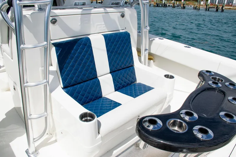 Slide: The Image of 2022 SeaVee 390Z boat interior with blue quilted seating and rod holders. - 35