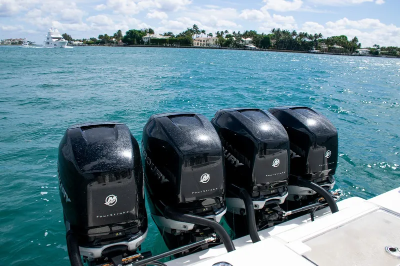 Slide: The Image of Four Mercury outboard engines on a 2022 SeaVee 390Z boat in clear blue water. - 41