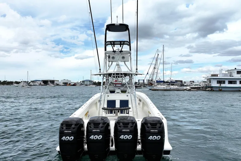 Slide: The Image of 2022 SeaVee 390Z boat with four powerful outboard engines docked in a marina. - 5