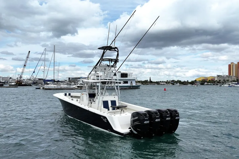 Slide: The Image of 2022 SeaVee 390Z boat with four outboard engines on a calm harbor. - 6