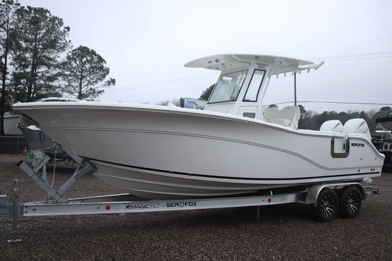 The Image of 2026 Sea Fox 268 Commander boat on trailer, parked outdoors. - 1