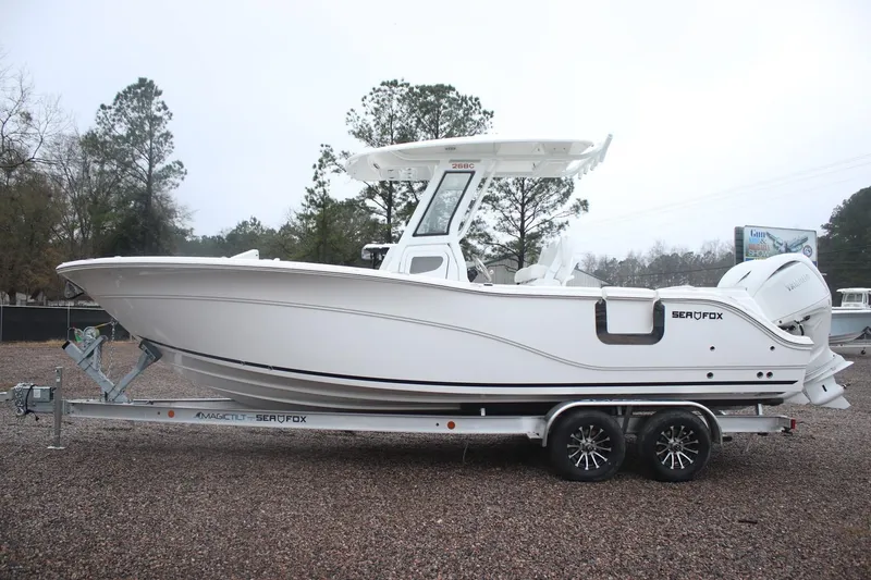 Slide: The Image of 2026 Sea Fox 268 Commander boat on trailer, parked outdoors. - 18