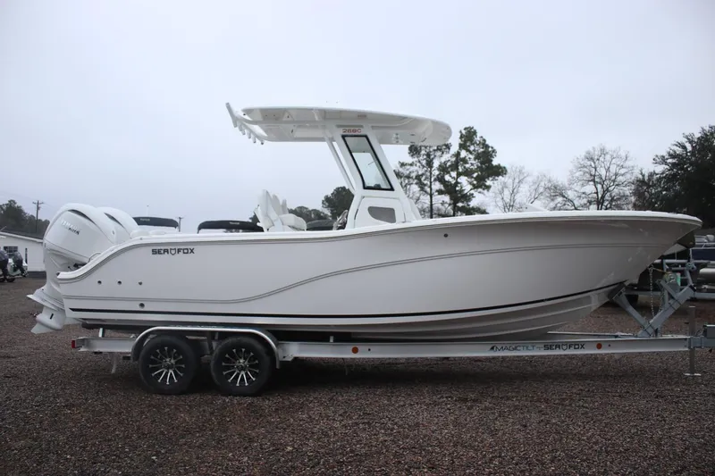 Slide: The Image of 2026 Sea Fox 268 Commander boat on trailer, side view, overcast day. - 19