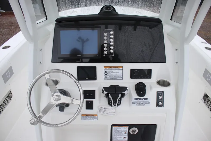 Slide: The Image of Helm of 2026 Sea Fox 268 Commander with steering wheel and navigation controls. - 7