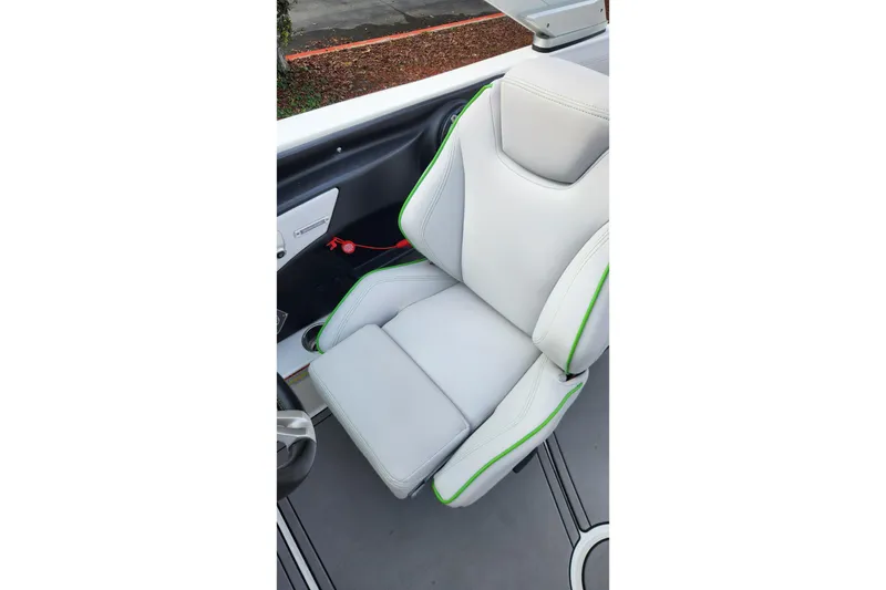 Slide: The Image of 2017 MasterCraft X23 boat seat with white upholstery and green accents. - 10
