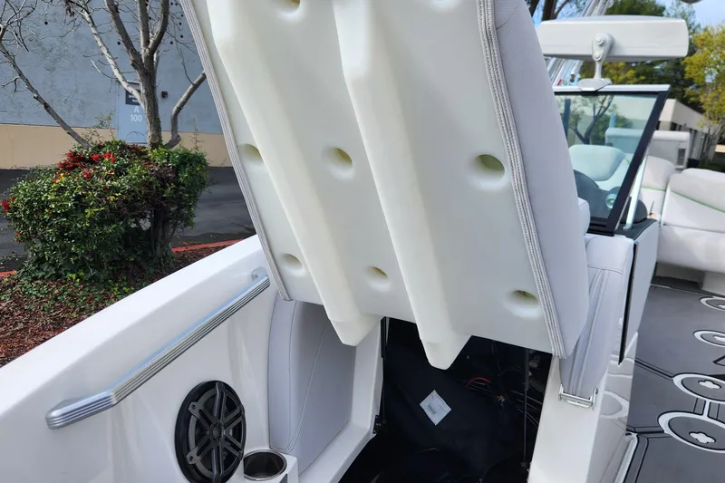 Slide: The Image of 2017 MasterCraft X23 boat interior with open storage compartment and speaker. - 15