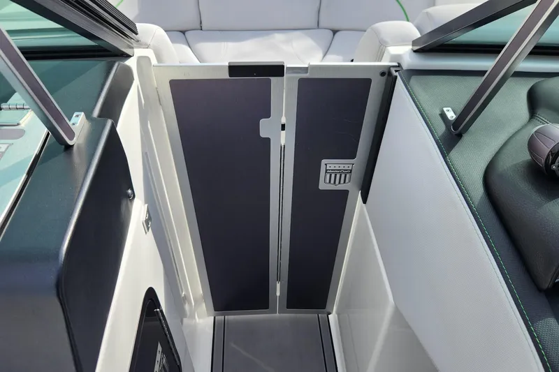 Slide: The Image of 2017 MasterCraft X23 boat interior with open door and seating area. - 18