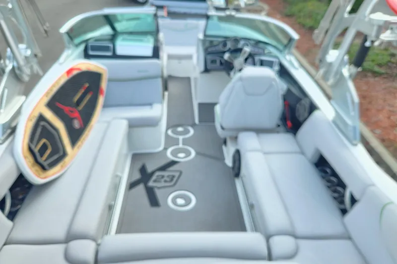 Slide: The Image of 2017 MasterCraft X23 boat interior with seating and surfboard, showcasing luxury and functionality. - 3