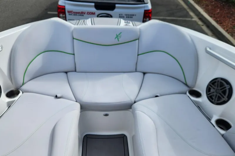 Slide: The Image of 2017 MasterCraft X23 boat interior with white seating and green accents. - 4