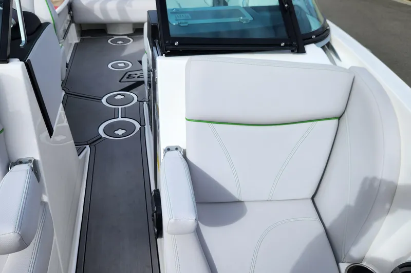 Slide: The Image of 2017 MasterCraft X23 boat interior with white seating and stylish flooring design. - 5