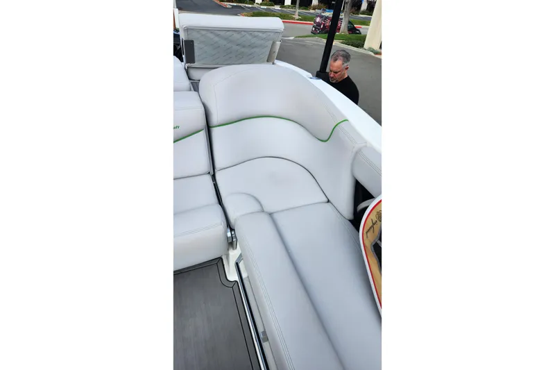 Slide: The Image of 2017 MasterCraft X23 boat interior with white cushioned seating and green accents. - 7