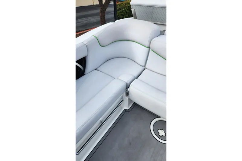 Slide: The Image of 2017 MasterCraft X23 boat interior with white and green-accented seating. - 8