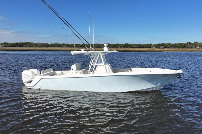 Slide: The Image of 2022 SeaVee 322Z boat on calm water under clear blue sky. - 10
