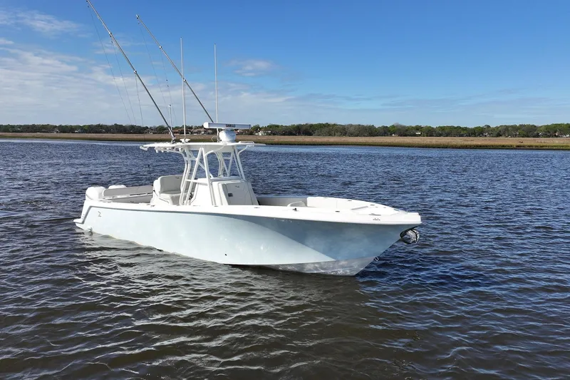 Slide: The Image of 2022 SeaVee 322Z boat on calm water under clear blue sky. - 11