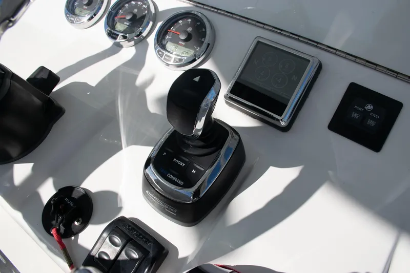 Slide: The Image of Control panel of 2022 SeaVee 322Z boat with gauges and joystick. - 13