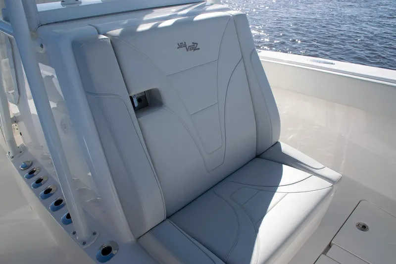 Slide: The Image of 2022 SeaVee 322Z boat seat with sleek design, overlooking water. - 14